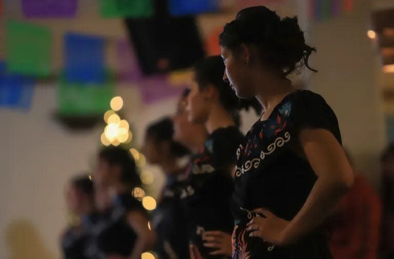 Genesis Davila, a member of Karina’s court as well as her friend and teammate, watches from the side of the dance floor.