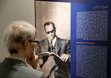 Foreign visitor reads the biography of the late Egyptian writer Naguib Mahfouz after the official opening of the museum in Cairo