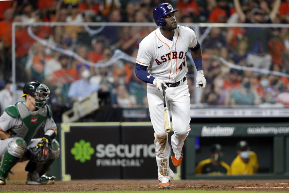 Houston Astros' Yordan Alvarez watches his home run as he heads to first base, next to Oakland Athletics catcher Sean Murphy during the sixth inning of a baseball game Thursday, April 8, 2021, in Houston. (AP Photo/Michael Wyke)