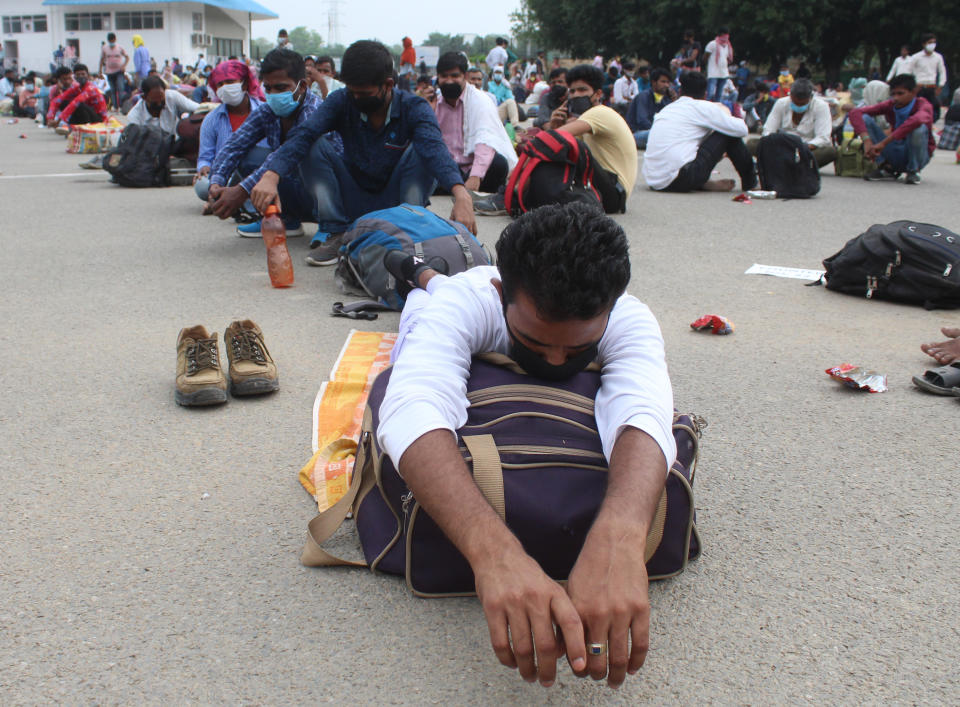 GURUGRAM, INDIA - MAY 13: Migrants waiting to be ferried from Tau Devi Lal Stadium to the railway station from where they will board a Shramik Special train to Bihar, on May 13, 2020 in Gurugram, India. (Photo by Yogendra Kumar/Hindustan Times via Getty Images)