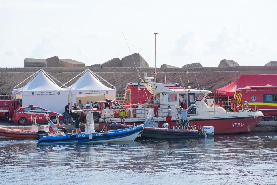 Italian emergency services gather in the port of Porticello on the Sicilian coast on the third day of the search for six missing tourists after the luxury yacht Bayesian sank in a storm on Monday while moored about half a mile off the coast of Porticello. The Italian coast guard has not ruled out the possibility that the missing are still alive, with experts speculating that air pockets may have formed when the yacht sank. Date of photo: Wednesday, August 21, 2024.