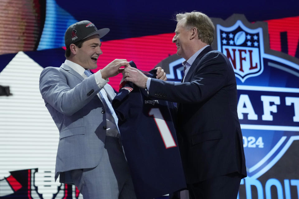 North Carolina quarterback Drake Maye, left, celebrates with NFL Commissioner Roger Goodell after being chosen by the New England Patriots with the third overall pick during the first round of the NFL football draft, Thursday, April 25, 2024, in Detroit. (AP Photo/Jeff Roberson)