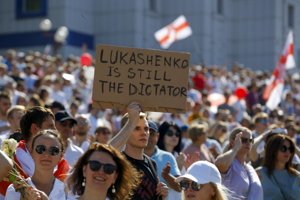 Belarusian opposition supporters rally in the center of Minsk, Belarus, Sunday, Aug. 16, 2020. Opposition supporters whose protests have convulsed the country for a week aim to hold a major march in the capital of Belarus. Protests began late on Aug. 9 at the closing of presidential elections. (AP Photo/Sergei Grits)