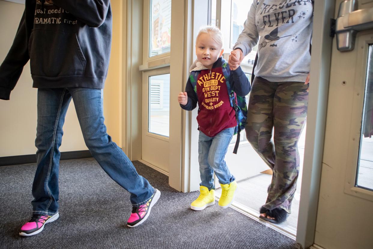 Lucian Fenn walks in with his family, ready for his first day in kindergarten.