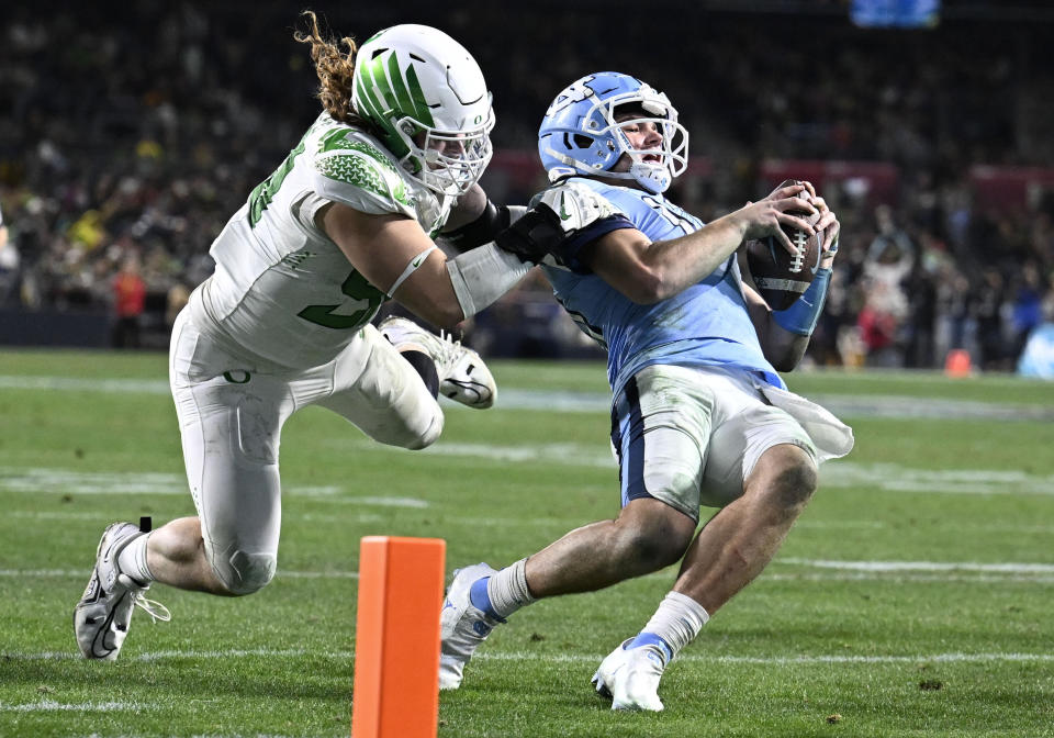 North Carolina quarterback Drake Maye (10) is tackled by Oregon defensive lineman Casey Rogers (98) during the second half of the Holiday Bowl NCAA college football game Wednesday, Dec. 28, 2022, in San Diego. (AP Photo/Denis Poroy)