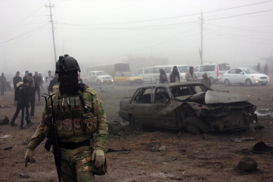 An Iraqi soldier stands guard at the site of a bomb attack in Balad Ruz, in northeastern Iraq.