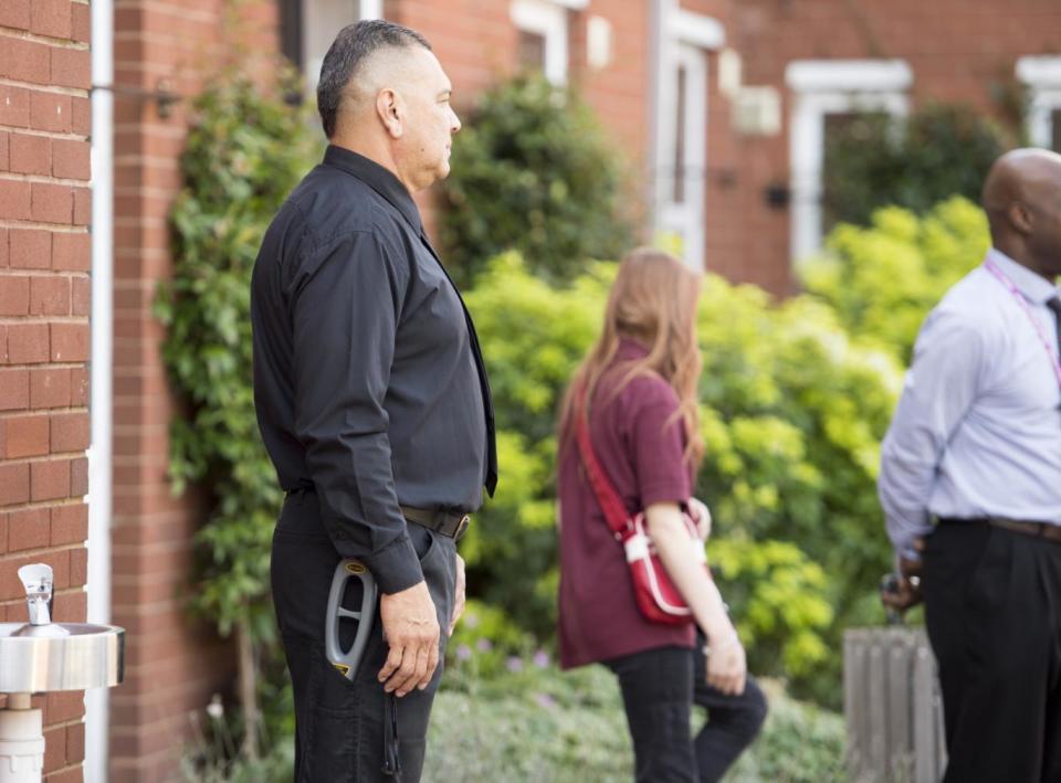 Lockdown: top, a security guard stands ready to frisk Abbey Manor students as they arrive at the referral unit (Jeremy Selwyn)