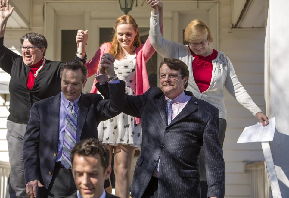 From left back row, Carol Schall , Emily Schall-Townley,16, daughter of Schall and Townley and Mary Townley , Tim Bostic and Tony London celebrate the Thursday's ruling by federal Judge Arenda Wright Allen that Virginia's same-sex marriage ban was unconstitutional on Friday, Feb. 14, 2014 in Norfolk, Va. Wright Allen on Thursday issued a stay of her order while it is appealed, meaning that gay couples in Virginia still won’t be able to marry until the case is ultimately resolved. An appeal will be filed to the 4th District Court of Appeals, which could uphold the ban or side with Wright Allen. At the bottom of photo is Adam Umhoefer, Executive Director of the American Foundation for Equal Rights. (AP Photo/The Virginian-Pilot, Bill Tiernan) MAGS OUT