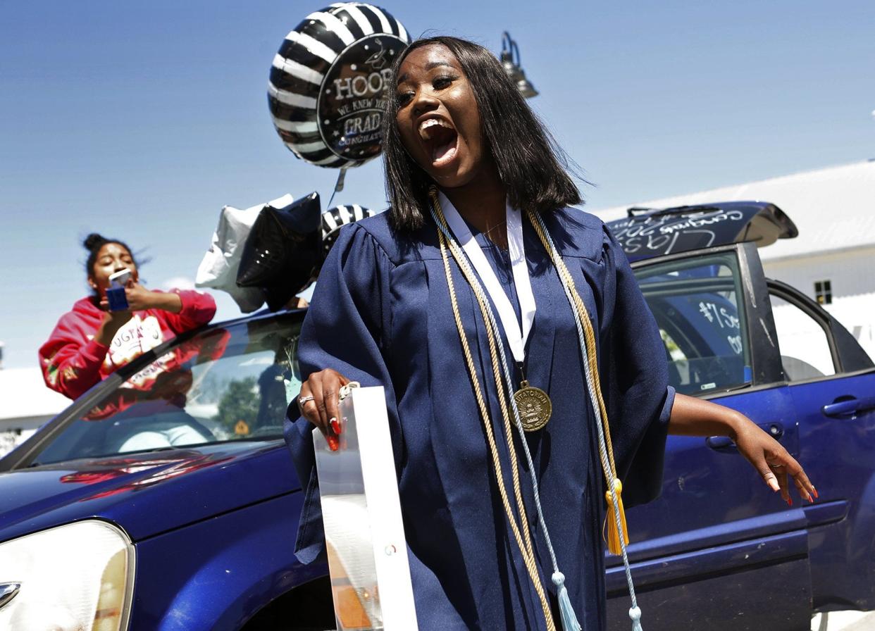 Terriona Watkins  expresses her surprise upon receiving a new laptop at her graduation ceremony from KIPP May 31. This is the first graduating class for KIPP a Columbus Charter School. Each graduate received a new laptop as a surprise