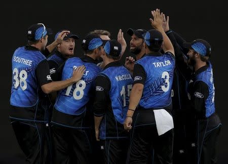 New Zealand team mates celebrate after South Africa's Faf du Plessis was caught behind during their Cricket World Cup semi final match in Auckland, March 24, 2015. REUTERS/Anthony Phelps