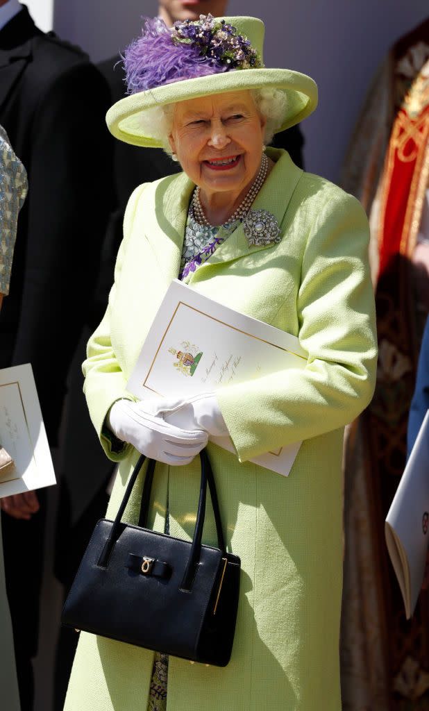 <p>The Queen never shies from bright colors, and this lime green silk tweed with dress in lime, lemon, purple and gray floral print was a real showstopper. But it may also have been a message for the happy couple: Purple may be a nod to the Queen’s approval of the marriage, while green is a color of growth, rebirth, respect and intention for the future, color consultant June McLeod <a href="https://www.goodhousekeeping.com/beauty/fashion/a20075728/queen-elizabeth-royal-wedding-dress/" rel="nofollow noopener" target="_blank" data-ylk="slk:previously explained to GoodHousekeeping.com;elm:context_link;itc:0" class="link ">previously explained to GoodHousekeeping.com</a>. </p>