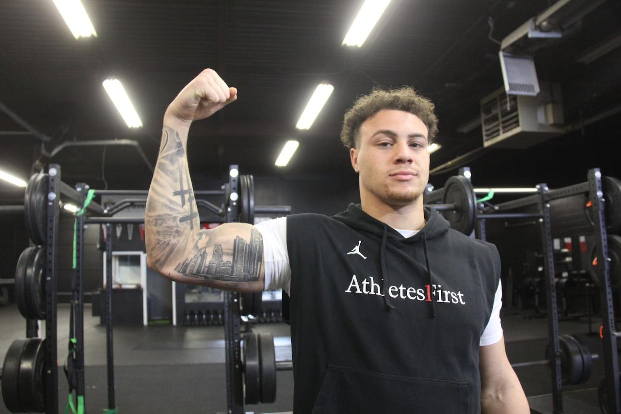 Theo Johnson, who spent much of his life in Windsor and played football at Holy Names Catholic High  School, will be one of the players in the NFL Draft in Detroit, Mich. Johnson says the coincidence of the draft being held in Detroit for his draft year couldn't be better — showing off a tattoo of the city's skyline on his bicep.   (Michael Evans/CBC - image credit)