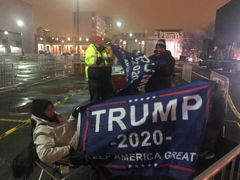 Elizabeth Sorenson, left, and her sister-in-law Linda Sorenson, behind flag, were the first in line for President Donald Trump's campaign rally. They set up their chairs at 4:30 p.m. Monday in the parking lot across from the UW-Milwaukee Panther Arena. Doors open at 3 p.m. Tuesday for the 7 p.m. rally.