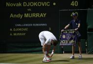 Great Britain's Andy Murray ties his shoe laces in his Men's Final against Serbia's Novak Djokovic during day thirteen of the Wimbledon Championships at The All England Lawn Tennis and Croquet Club, Wimbledon.