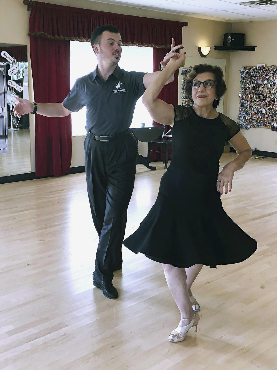 In this Oct. 7, 2019, photo, dance instructor Ned Pavlovic, a native of Serbia, teaches his student Rouhy Yazdani, a native of Iran who now lives in Milford, Conn., some ballroom dance moves at the Fred Astaire Dance Studio in Orange, Conn. Owners of Ballroom dance studios including the Fred Astaire studio say the immigration clampdown has made it even more difficult to find qualified instructors. The small business owners, U.S. dance studio chains and immigration attorneys say there's greater backlogs for visa applications and an overall increase in evidence requests, including for redundant and unnecessary documents. (AP Photo/Susan Haigh)