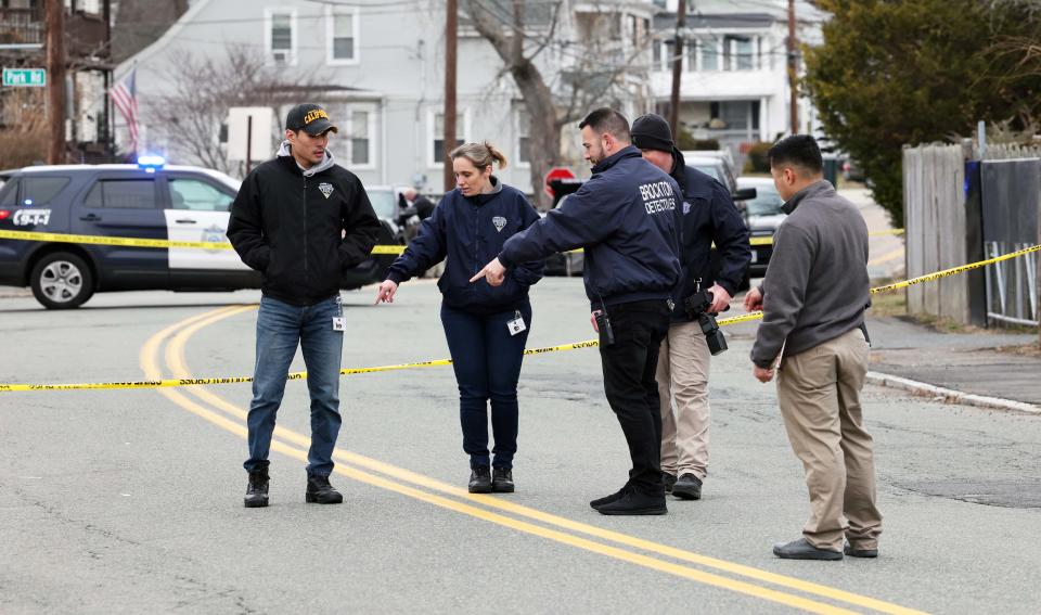 Brockton police and Massachusetts State Police investigate a crime scene next to 44 Belmont Ave. where a man was stabbed to death on Saturday, March 25, 2023.