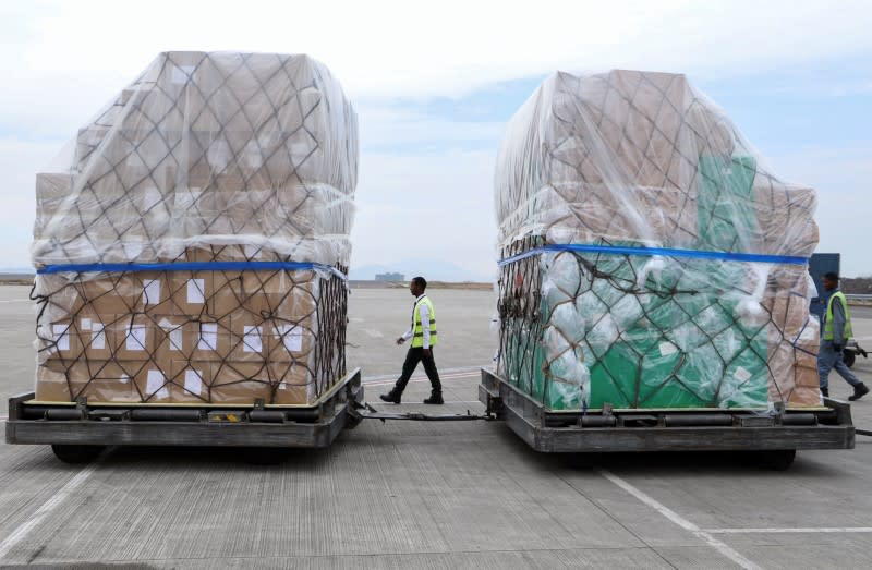 Ethiopian Airlines workers unload a consignment of medical donation from Chinese billionaire Jack Ma and Alibaba Foundation in Addis Ababa
