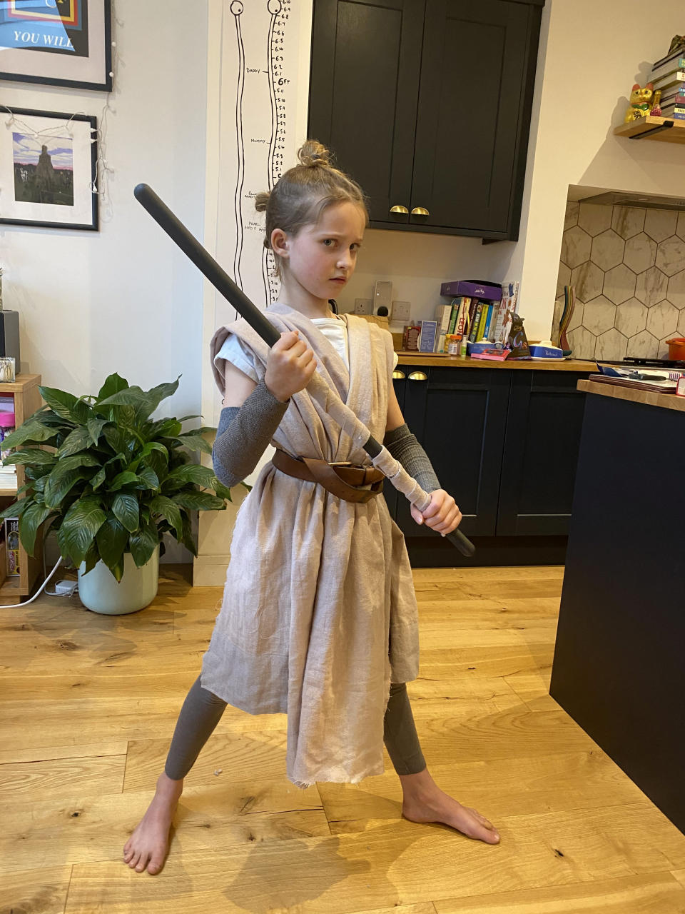 Pearl Parkin dressed as Rey from Star Wars. See SWNS story SWBRcostume. An eight-year old girl is raising money for charity by dressing-up every day as characters like Ziggy Stardust, Lady Gaga - and Jacky Weaver. Pearl Parkin started the challenge on February 2 and has managed to become a new star each morning. Her creations include Billie Eilish, Frida Kahlo, Rey Skywalker, Elton John, John Lennon - and Handforth Parish Council's Weaver. Pearl, from Bath, Somerset, has raised more than £700 for Save the Children and hopes to reach £1,000 by March 8.
