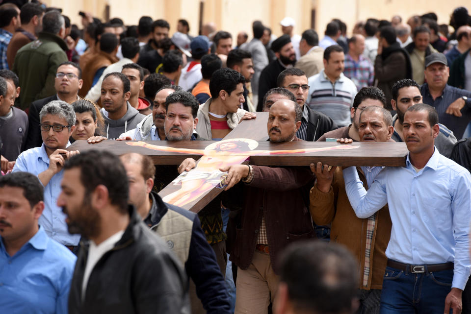 Mourners carry a large cross during a funeral procession on April 10, 2017 at the Monastery of Marmina in the city of Borg El-Arab, for the victims of the blast at the Coptic Christian Saint Mark's church in Alexandria the previous day.