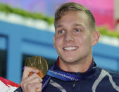 Gold medalist United States' Caeleb Dressel hold sup his medal after winning the men's 50m butterfly final at the World Swimming Championships in Gwangju, South Korea, Monday, July 22, 2019. (AP Photo/Lee Jin-man)