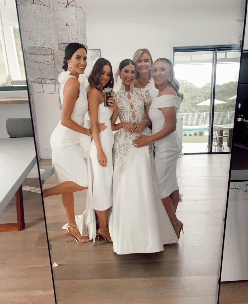 Erin Holland wearing a wedding dress with her bridesmaids Lauren Vickers, Lucy Turner, Margarita Nazarenko and Rachel Khawaja