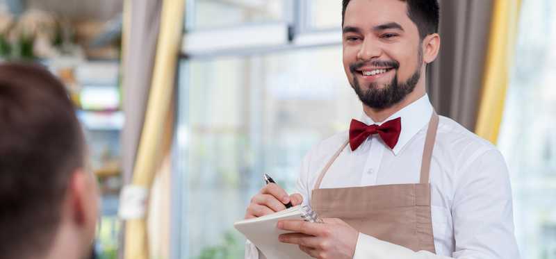 A waiter taking a dining order.