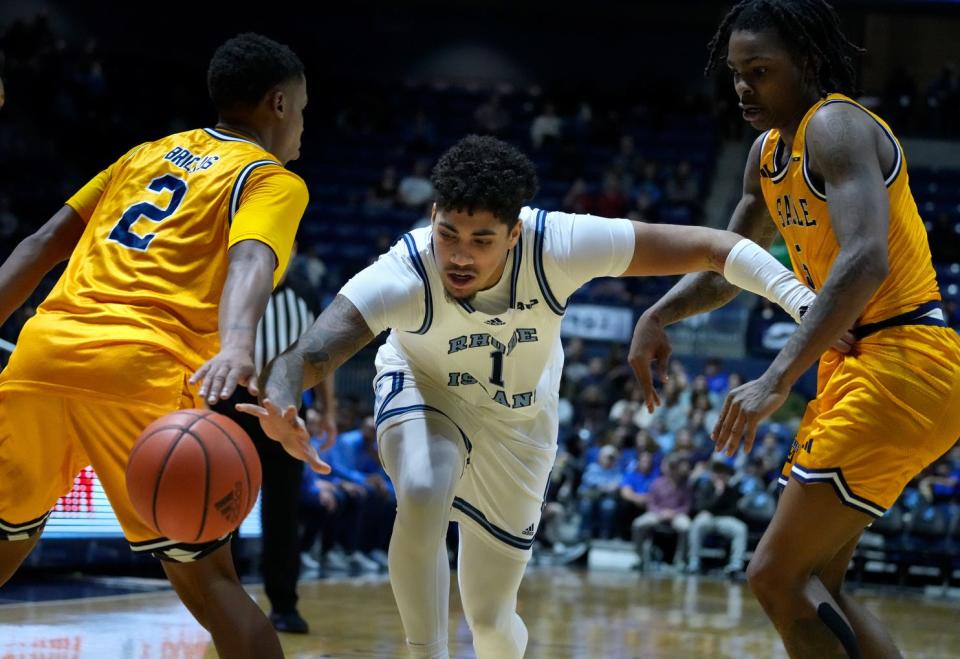 Rams guard Luis Kortright splits La Salle defenders as he lunges to regain control of the ball in the first half of their game earlier this week.