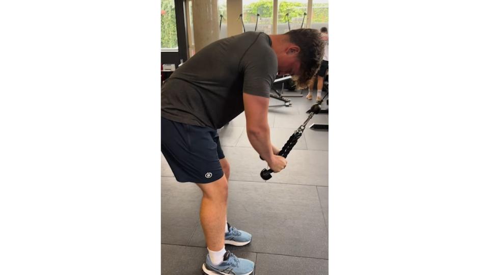 A teenage boy with a resistance equipment at the gym