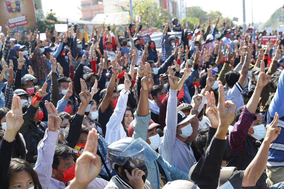 Protesters flash the three-fingered salute, a symbol of resistance, during a protest in Mandalay, Myanmar, Tuesday, Feb. 9, 2021. Protesters continued to gather Tuesday morning in major cities breaching Myanmar's new military rulers ban of public gathering of five or more issued on Monday intended to crack down on peaceful public protests opposing their takeover. (AP Photo)