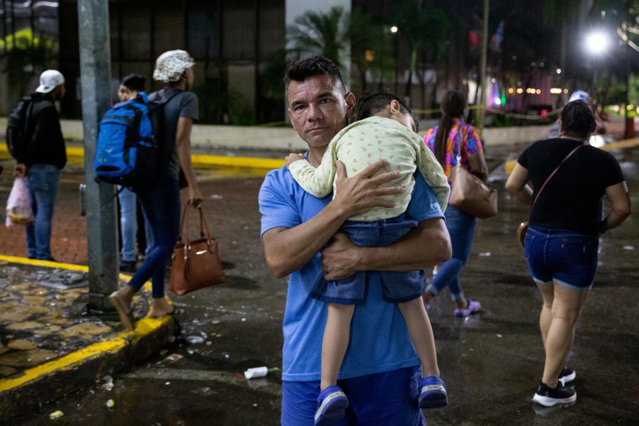 Eduardo Jose Parra Medina, 40, carries his 3-year-old son, Andres Eduardo Parra Prieto, near the main plaza in Tapachula. Parra Medina had just arrived in Tapachula with other family members who had crossed the Darien Gap in Panama a few weeks prior.