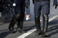 Riot police officers detain a protester during a demonstration Saturday, Feb.16, 2019 in Paris. Yellow vest protesters are holding scattered demonstrations around Paris and the rest of France amid waning support for their movement. (AP Photo/Thibault Camus)