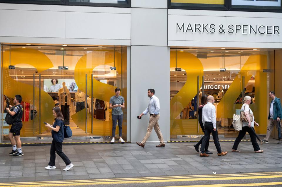 pedestrians walk past the British multinational retailer Marks & Spencer (M&S) store seen in Hong Kong. (Photo by Sebastian Ng / SOPA Images/Sipa USA)