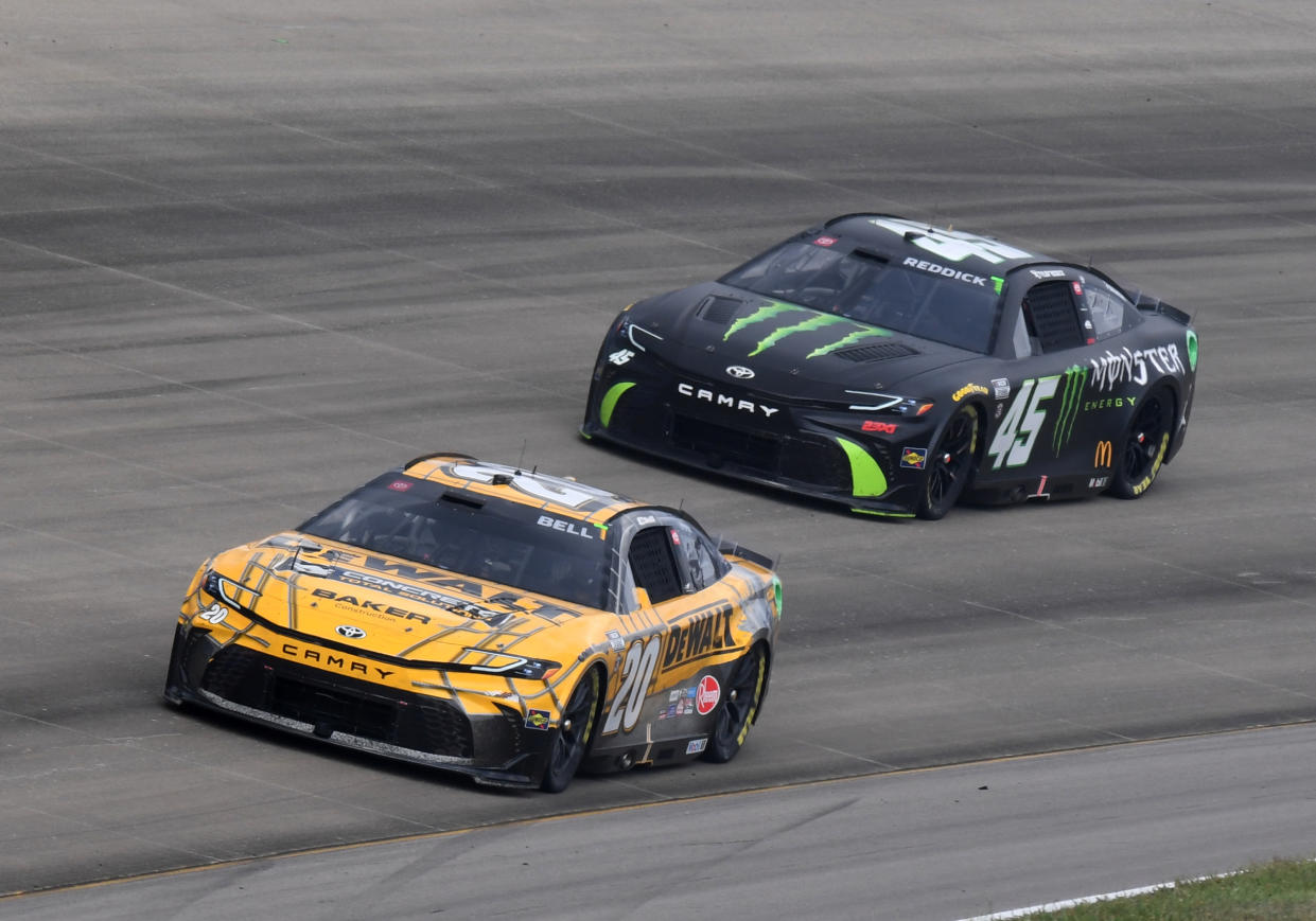 NASHVILLE, TN - JUNE 30: Christopher Bell (#20 Joe Gibbs Racing DEWALT Toyota) and Tyler Reddick (#45 23XI Racing Monster Energy Toyota) races through Turn 3 during the running of the NASCAR Cup Series Ally 400 on June 30, 2024, at Nashville Superspeedway in Lebanon, TN. (Photo by Jeffrey Vest/Icon Sportswire via Getty Images)