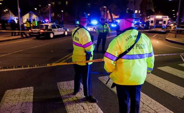 Massachusetts State Police, Cambridge Police and MIT Police search at the scene of the shooting. Photo: AP