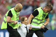 Soccer Football - World Cup - Final - France v Croatia - Luzhniki Stadium, Moscow, Russia - July 15, 2018 Stewards apprehend a pitch invader REUTERS/Carl Recine