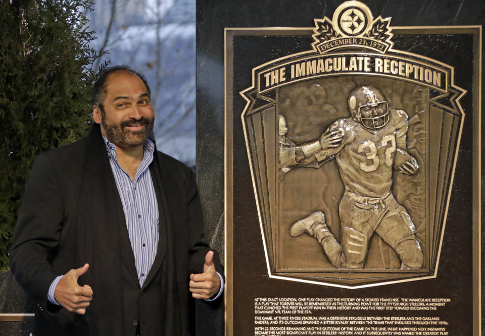 FILE - In this Dec. 22, 2012, file photo, former Pittsburgh Steelers Hall of Fame running back Franco Harris stands on the spot of the "Immaculate Reception" after a marker commemorating the 40th anniversary of the play was unveiled where Three Rivers Stadium once stood on the North Side of Pittsburgh. Harris’ scoop of a deflected pass and subsequent run for the winning touchdown in a 1972 playoff victory against Oakland _ has been voted the greatest play in NFL history. A nationwide panel of 68 media members chose the Immaculate Reception as the top play with 3,270 points and 39 first-place votes. (AP Photo/Gene J. Puskar, File)
