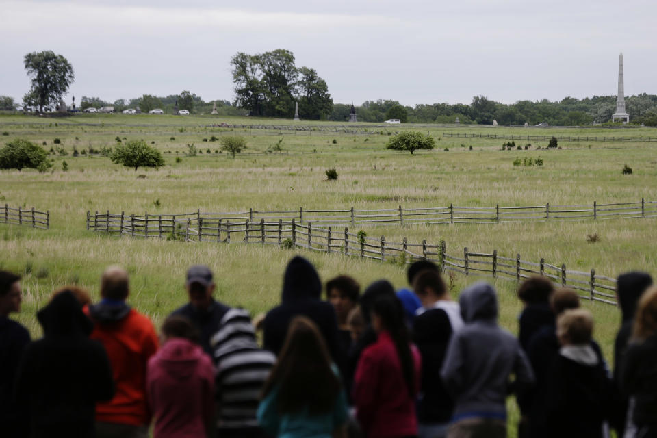 In this Friday, May 24, 2013 photo, tourists view the field of Pickett's Charge, in Gettysburg, Pa. Tens of thousands of visitors are expected for the 10-day schedule of events that begin June 29 to mark 150th anniversary of the Battle of Gettysburg that took that took place July 1-3, 1863. (AP Photo/Matt Rourke)