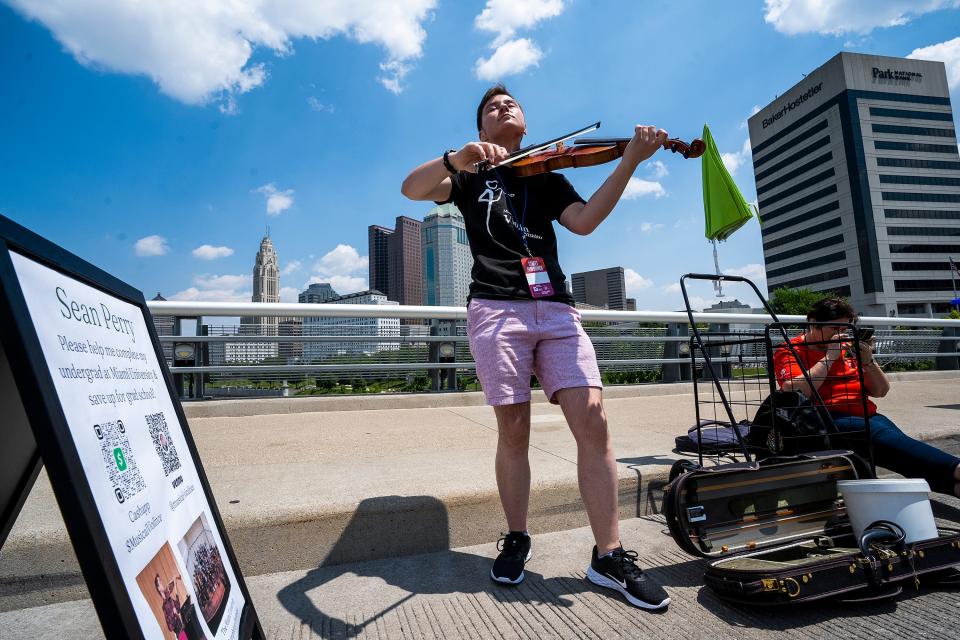 Violinist Sean Perry plays the violin Friday at the Columbus Arts Festival in downtown Columbus.