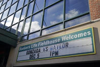 A sign outside of Bankers Life Fieldhouse shows the display for the Gonzaga vs. Baylor basketball game that was scheduled to play in an NCAA college basketball game, Saturday, Dec. 5, 2020, in Indianapolis. The game was canceled due to COVID. (AP Photo/Darron Cummings)