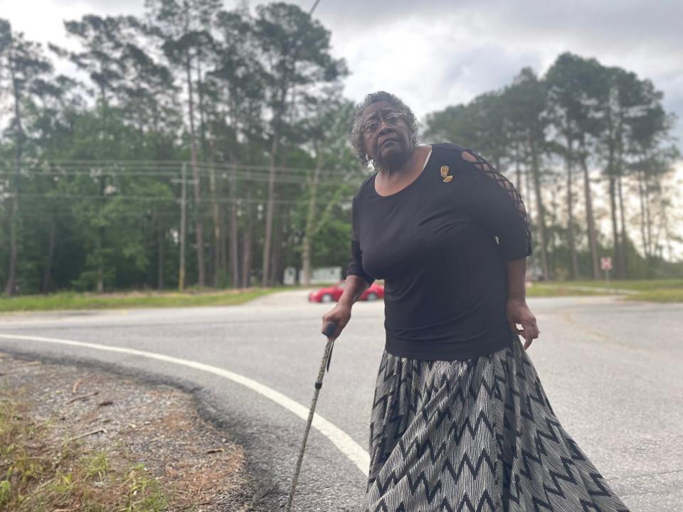 Georgia Benton stands at the corner of Saussy Road and Highway 21, where she points about the disparities in how developers maintain stormwater drainage on either side of the four-lane highway.