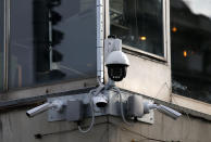 In this photo taken Sept. 25, 2019, high-tech video cameras hang from an office building in downtown Belgrade, Serbia. The cameras, equipped with facial recognition technology, are being rolled out across hundreds of cities around the world, particularly in poorer countries with weak track records on human rights where Beijing has increased its influence through big business deals. (AP Photo/Darko Vojinovic)