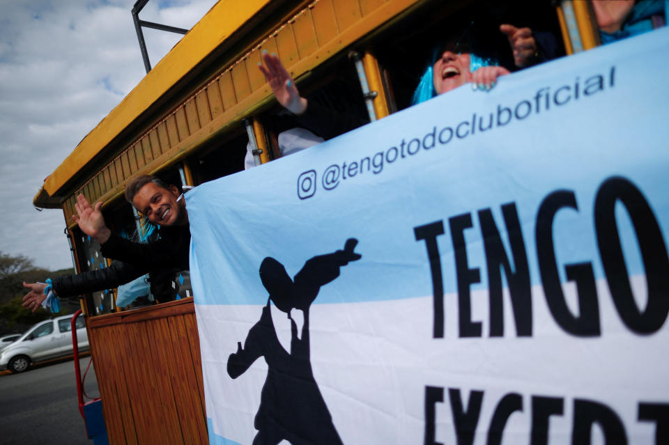 Argentine impersonator of Mexican singer Luis Miguel, Guillermo Elias, 50, waves from a joy train (a modified bus) next to members of Miguel's fan club as they travel to the stadium where the singer will perform tonight, in Buenos Aires, Argentina August 3, 2023. REUTERS/Agustin Marcarian