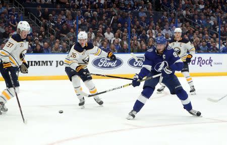 Feb 21, 2019; Tampa, FL, USA; Tampa Bay Lightning center Steven Stamkos (91) shoots against Buffalo Sabres center Casey Mittelstadt (37) and defenseman Rasmus Dahlin (26) during the third period at Amalie Arena. Mandatory Credit: Kim Klement-USA TODAY Sports