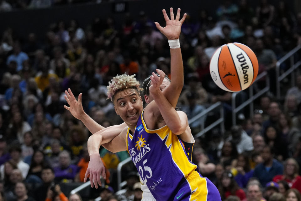 FILE - Indiana Fever guard Caitlin Clark fouls Los Angeles Sparks guard Layshia Clarendon (25) during the first half of a WNBA basketball game in Los Angeles, Friday, May 24, 2024. (AP Photo/Ashley Landis, File)