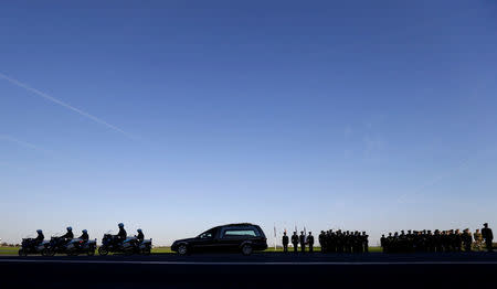 A car carrying a coffin with the remains of Czech cardinal Josef Beran leaves the Kbely airport in Prague, Czech Republic, April 20, 2018. REUTERS/David W Cerny