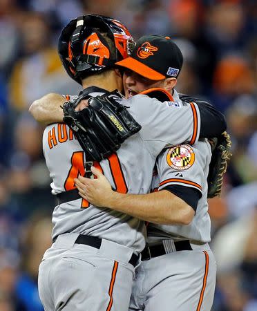 Oct 5, 2014; Detroit, MI, USA; Baltimore Orioles relief pitcher Zach Britton (53) and catcher Nick Hundley (40) celebrate after defeating the Detroit Tigers in game three of the 2014 ALDS baseball playoff game at Comerica Park. The Orioles move on to the ALCS with 2-1 win over the Tigers. Mandatory Credit: Rick Osentoski-USA TODAY Sports