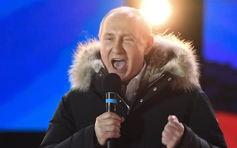 Vladimir Putin celebrates his win during a concert outside the Kremlin on Sunday celebrating the fourth anniversary of Crimea's annexation - Credit: Kirill Kudryavtsev/AFP