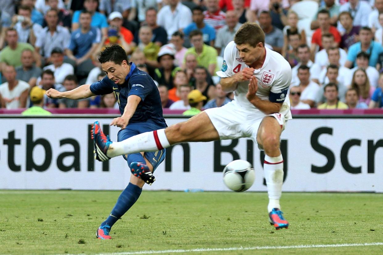 Samir Nasri of France scores their first goal past Steven Gerrard of England during the UEFA EURO 2012 group D match between France and England at Donbass Arena.