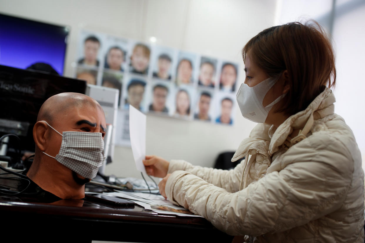 A software engineer tests a facial recognition program that identifies people when they wear a face mask at the development lab of the Chinese electronics manufacturer Hanwang (Hanvon) Technology in Beijing as the country is hit by an outbreak of the novel coronavirus (COVID-19), China, March 6, 2020. Picture taken March 6, 2020.  REUTERS/Thomas Peter