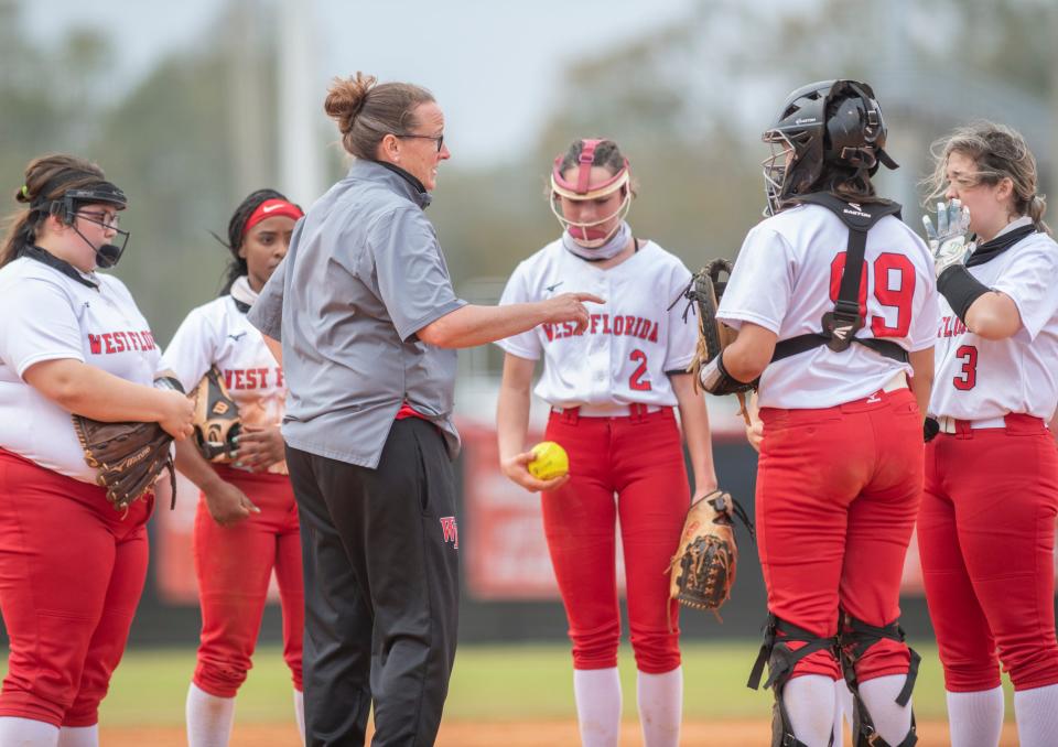 Head coach Belinda Pitman talks with her team in a timeout during the Niceville vs West Florida softball game at West Florida High School in Pensacola on Wednesday, March 17, 2021.  The Eagles ultimately beat the Jaguars 4-1.